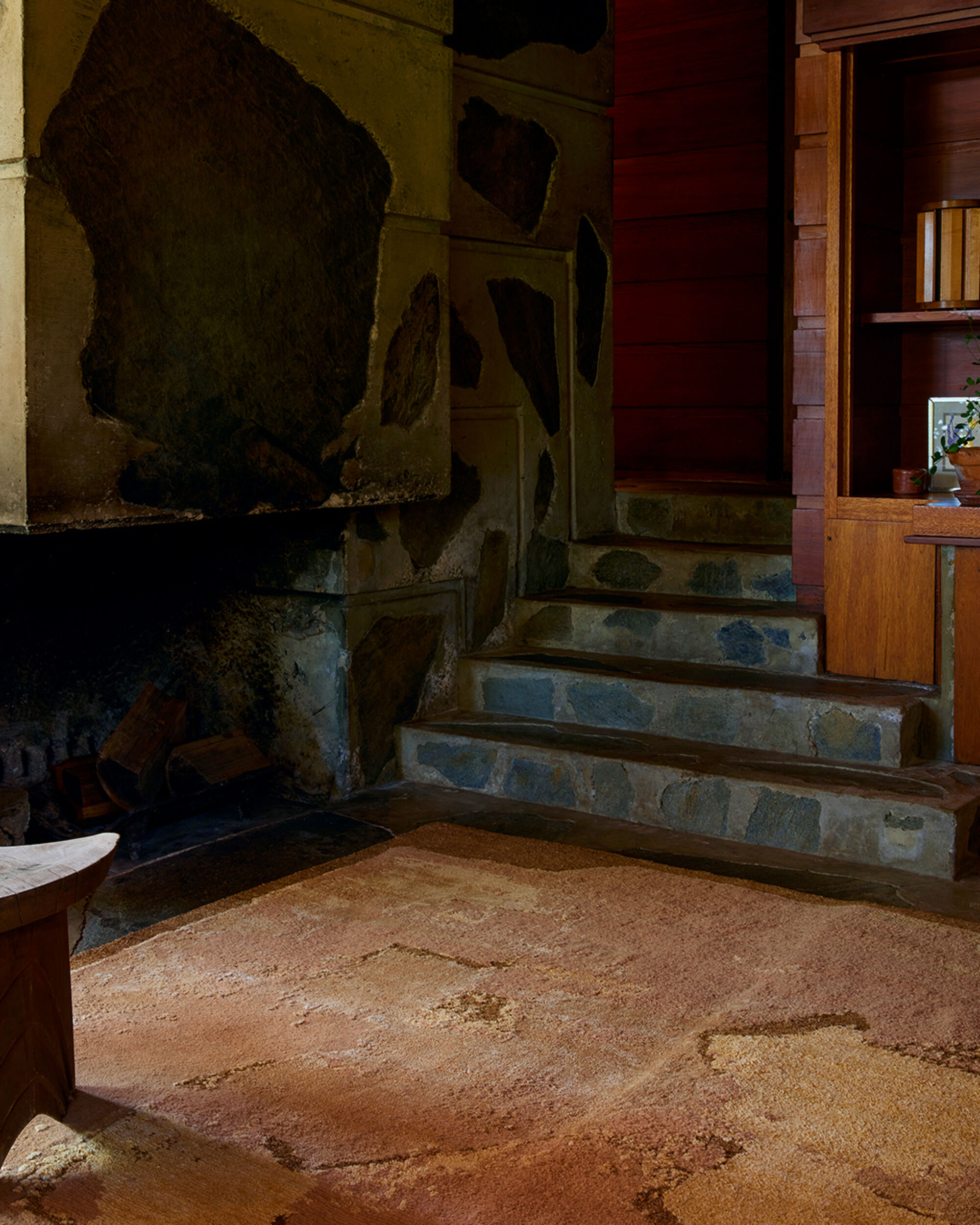 Marc philip terracotta rug stone fireplace